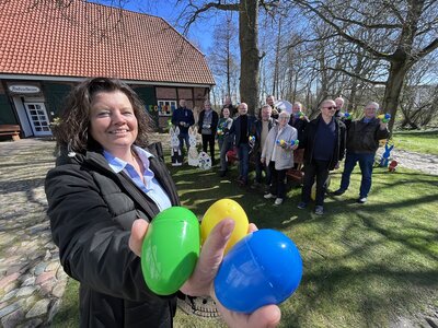 Bürgermeisterin hält bunte Ostereier in den Händen